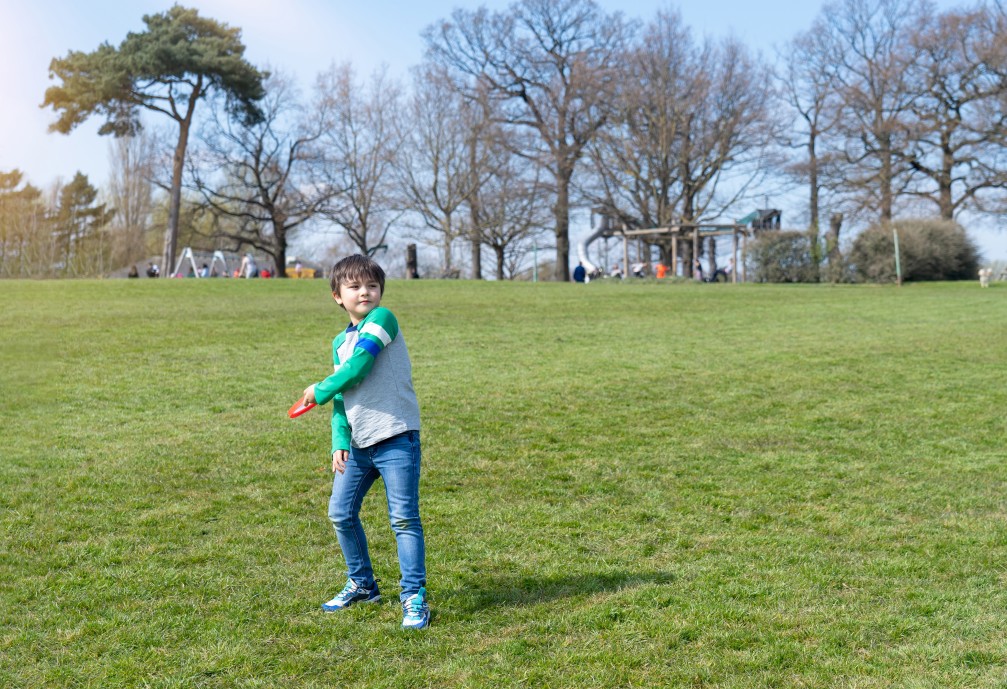 happy kid playing in the park child having fun playing outside in sunny day spring school boy have t20 ErvAL8