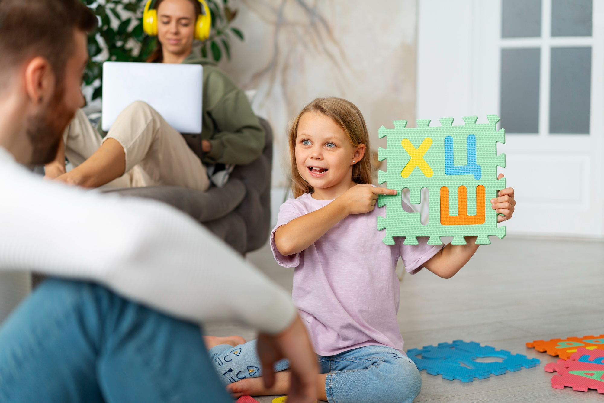 A child and a speech therapist engaged in a speech therapy session.